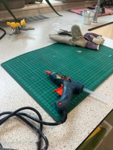 Glue gun on a green board at BACA as part of the Race to the Line STEM project